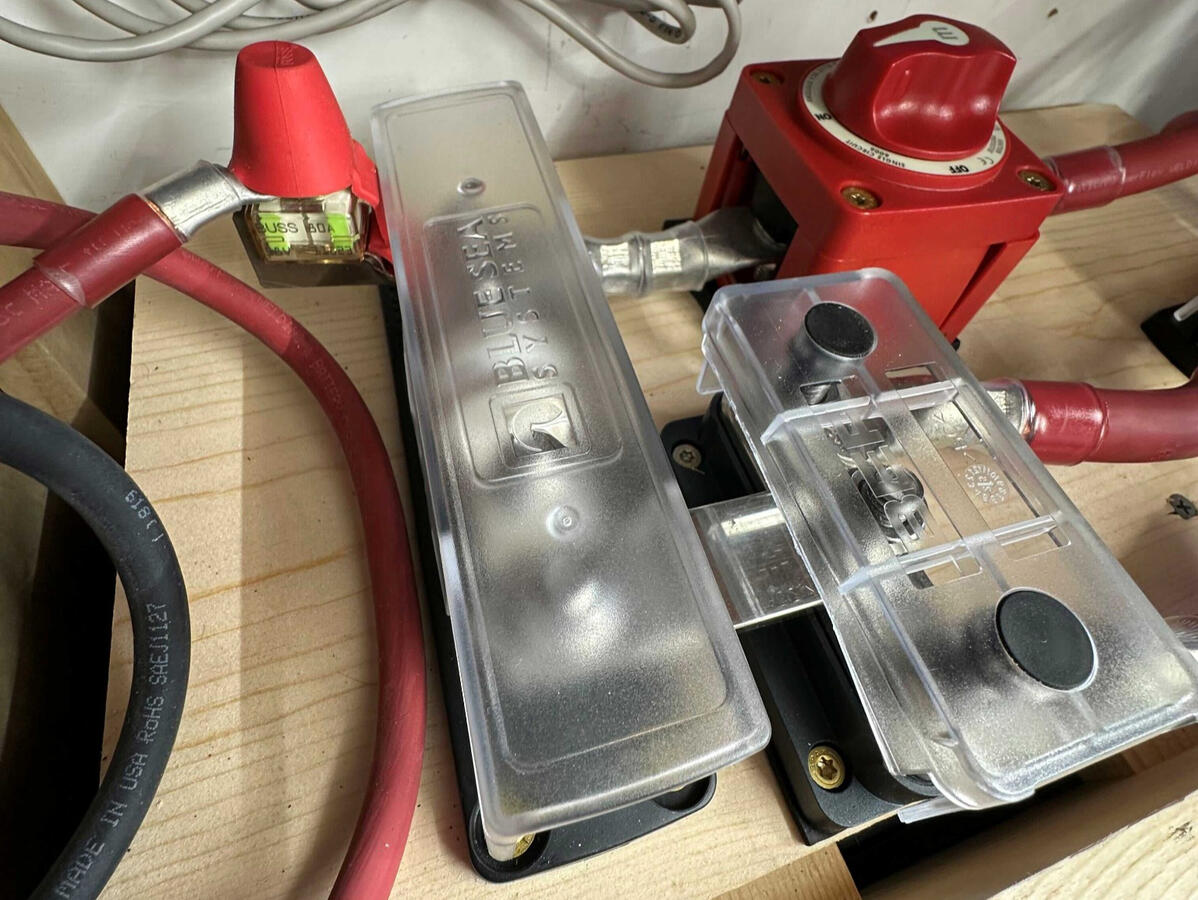 Lithium Battery Protection and Power Distribution Custom camper van electrical installation with Blue Sea Class T battery fuse protection, heavy-duty battery disconnect switch, and 4/0 power cables.